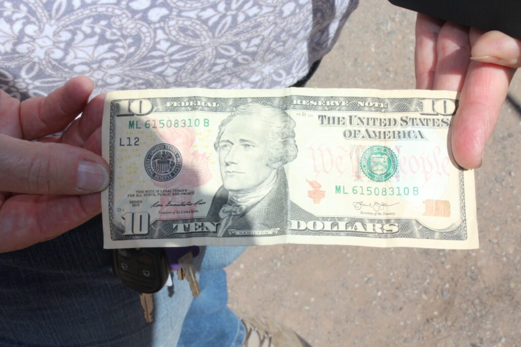 Holding a Ten Dollar Bill